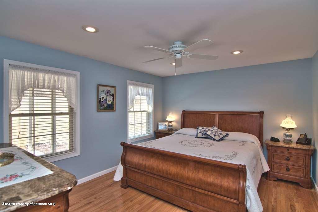 521 Summit Woods Road Moscow, PA 18444 - Photo 31 of 77 a bedroom with a large bed and wooden floor