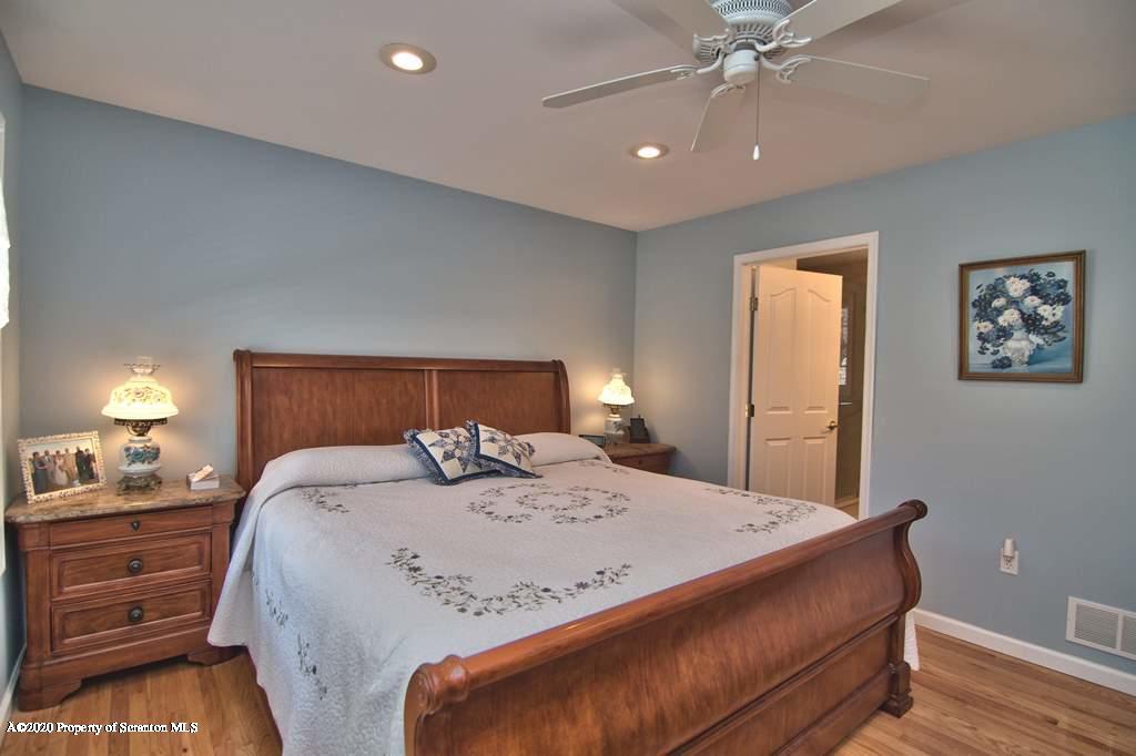 521 Summit Woods Road Moscow, PA 18444 - Photo 34 of 77 a bedroom with a bed and a lamp