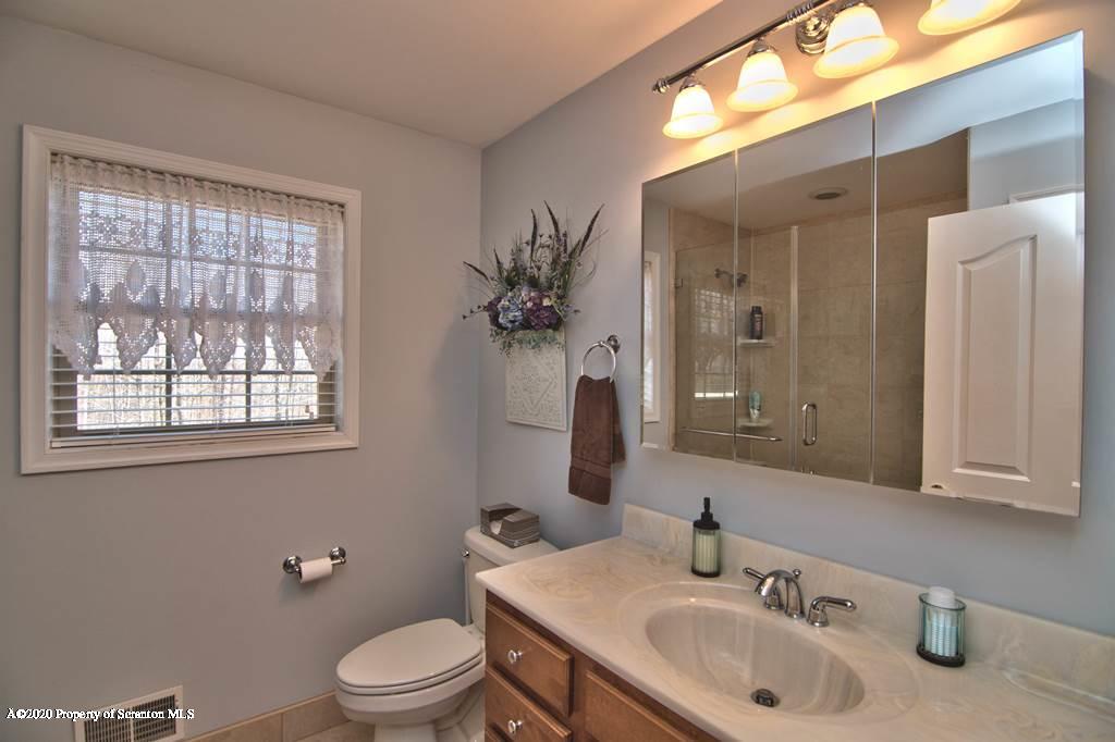 521 Summit Woods Road Moscow, PA 18444 - Photo 36 of 77 a bathroom with a sink toilet and shower