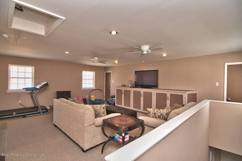 521 Summit Woods Road Moscow, PA 18444 - Photo 41 of 77 a living room with furniture and a flat screen tv