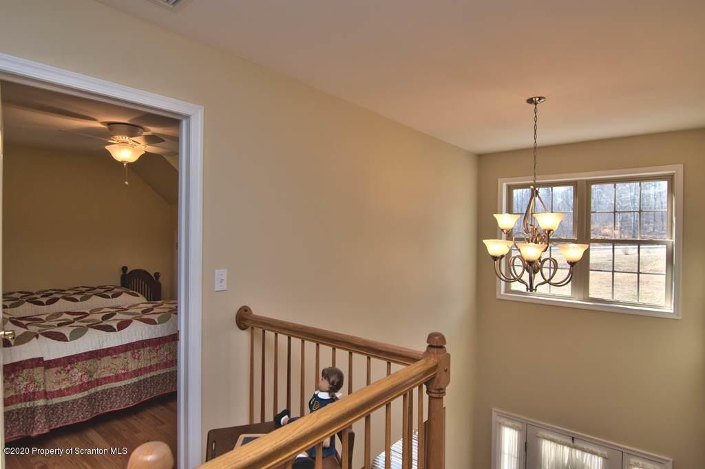 521 Summit Woods Road Moscow, PA 18444 - Photo 43 of 77 a view of a room that has a bed and a window in it
