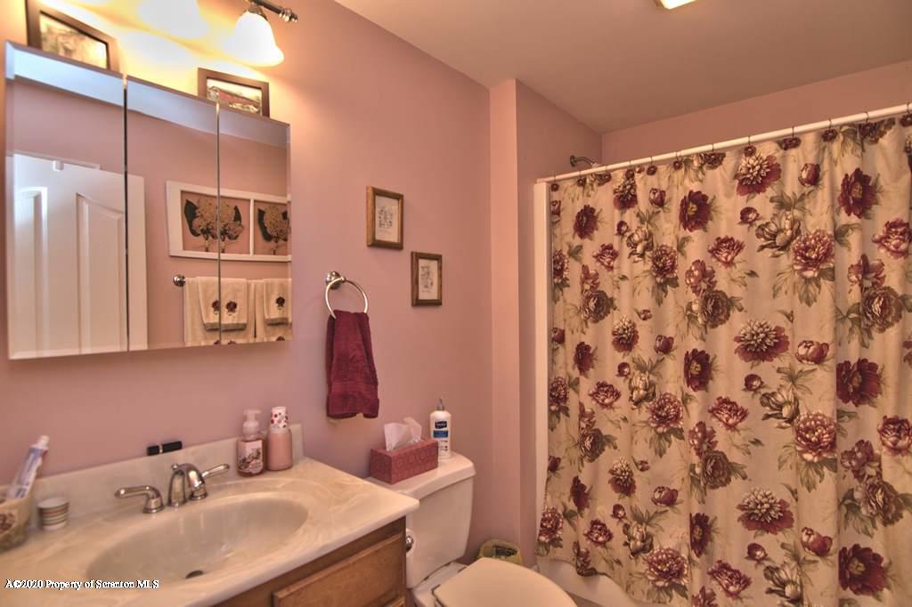 521 Summit Woods Road Moscow, PA 18444 - Photo 53 of 77 a bathroom with a sink and a mirror