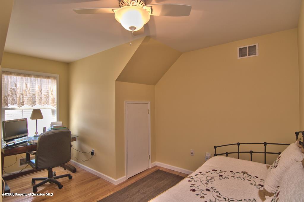 521 Summit Woods Road Moscow, PA 18444 - Photo 55 of 77 a bedroom with a bed and wooden floor