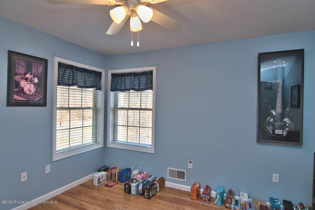 521 Summit Woods Road Moscow, PA 18444 - Photo 57 of 77 a bedroom with furniture and a window