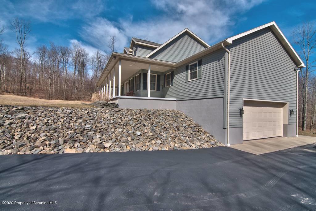 521 Summit Woods Road Moscow, PA 18444 - Photo 68 of 77 a front view of a house with a yard