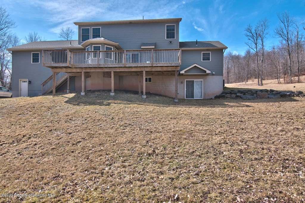 521 Summit Woods Road Moscow, PA 18444 - Photo 69 of 77 a front view of a house with yard garage and balcony