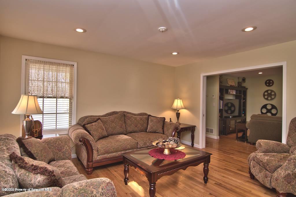 521 Summit Woods Road Moscow, PA 18444 - Photo 9 of 77 a living room with furniture a rug and a window