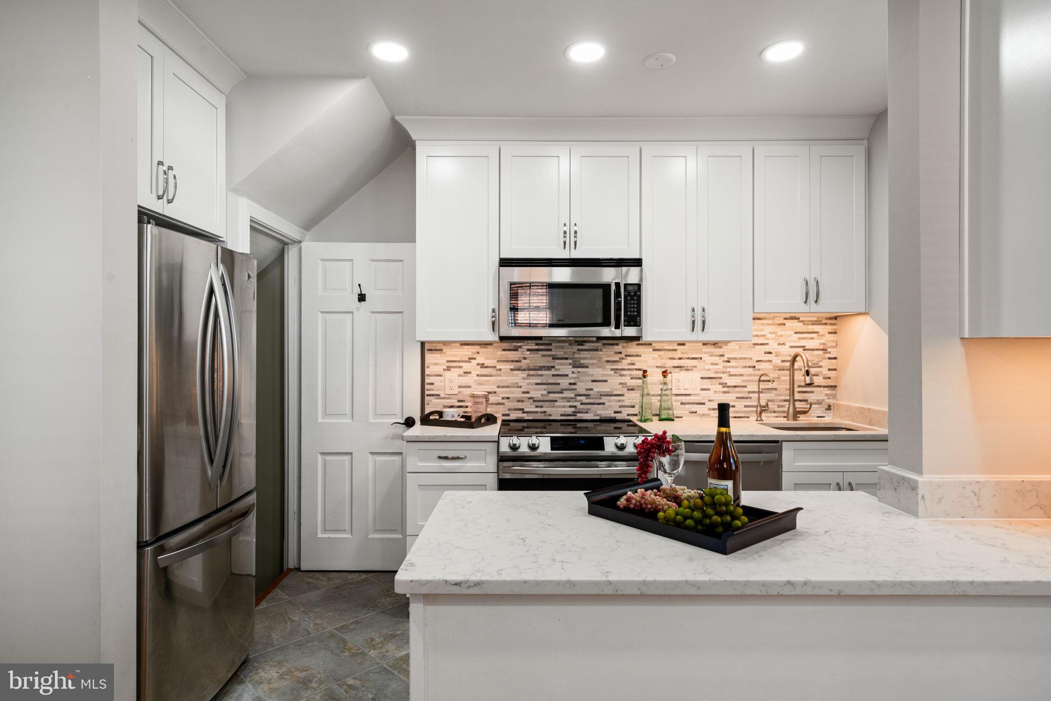 204 South Courthouse Road Arlington, VA 22204 - Photo 17 of 49 a kitchen with stainless steel appliances a refrigerator sink and cabinets