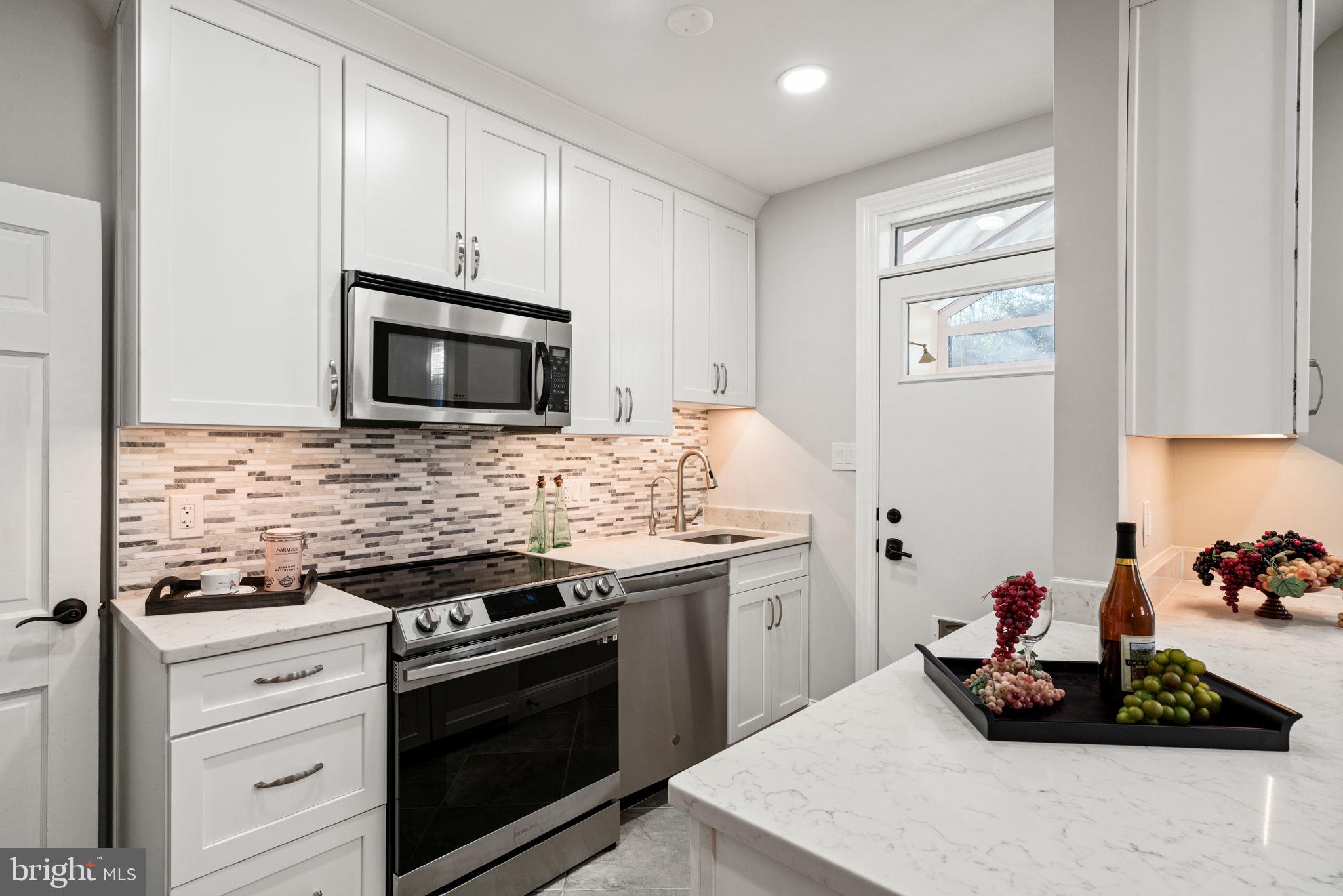 204 South Courthouse Road Arlington, VA 22204 - Photo 18 of 49 a kitchen with stainless steel appliances a sink stove and microwave