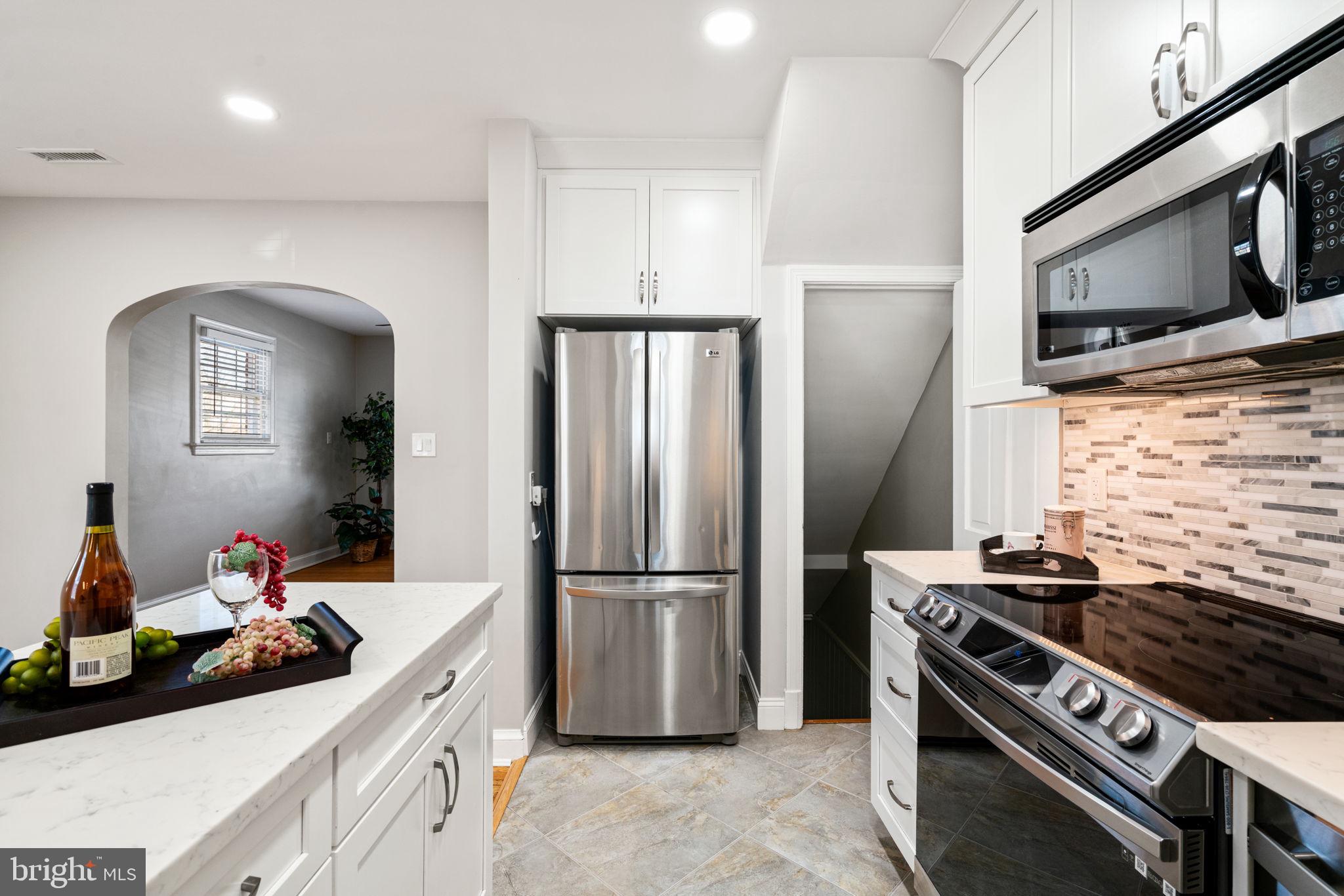204 South Courthouse Road Arlington, VA 22204 - Photo 20 of 49 a kitchen with stainless steel appliances a refrigerator a stove and a sink