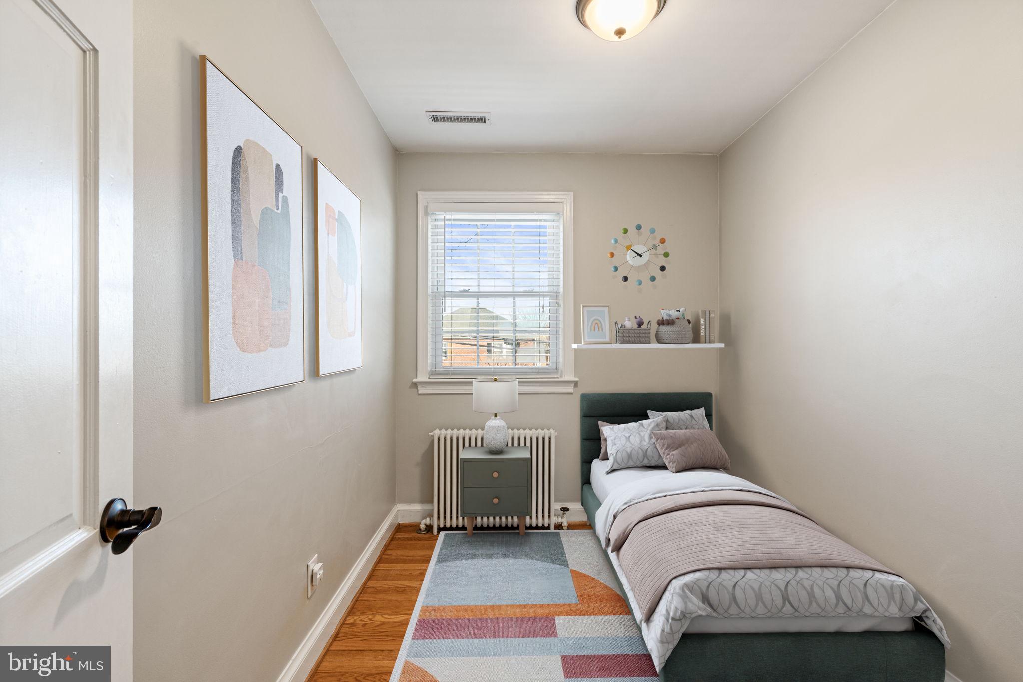204 South Courthouse Road Arlington, VA 22204 - Photo 6 of 49 a bedroom with a bed and wooden floor