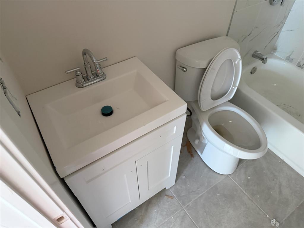 664 Haverhill Road West Palm Beach, FL 33415 - Photo 4 of 8 a bathroom with a toilet and a sink