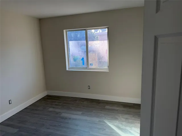 a view of a room with wooden floor