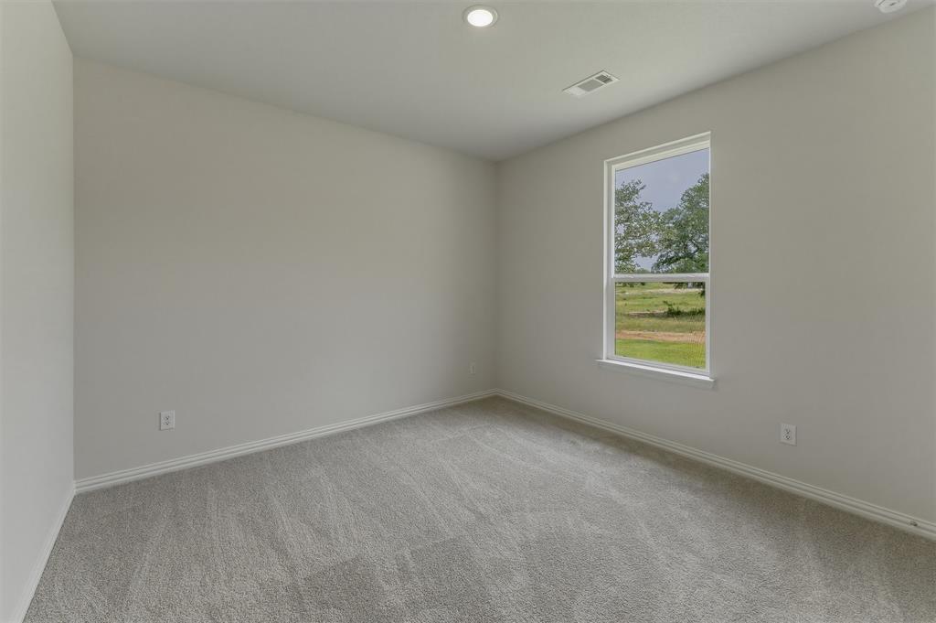 156 Oak Grv Way Springtown, TX 76082 - Photo 15 of 25 Spacious room featuring neutral paint, gray carpeting, a large window, recessed lighting, and white trim