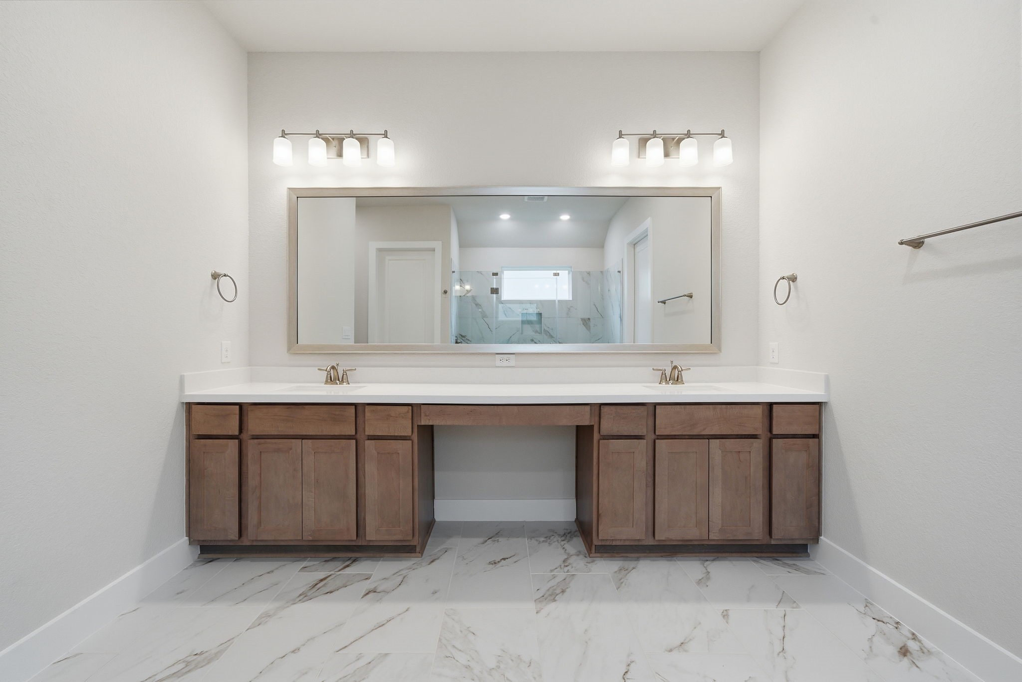 10026 Larkin Cove Willis, TX 77318 - Photo 27 of 46 a bathroom with a double vanity sink and a mirror