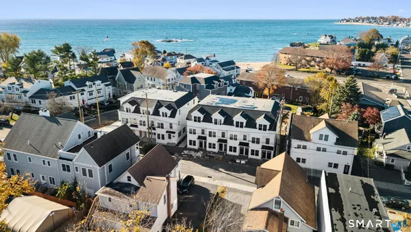 an aerial view of a building with outdoor space and ocean view
