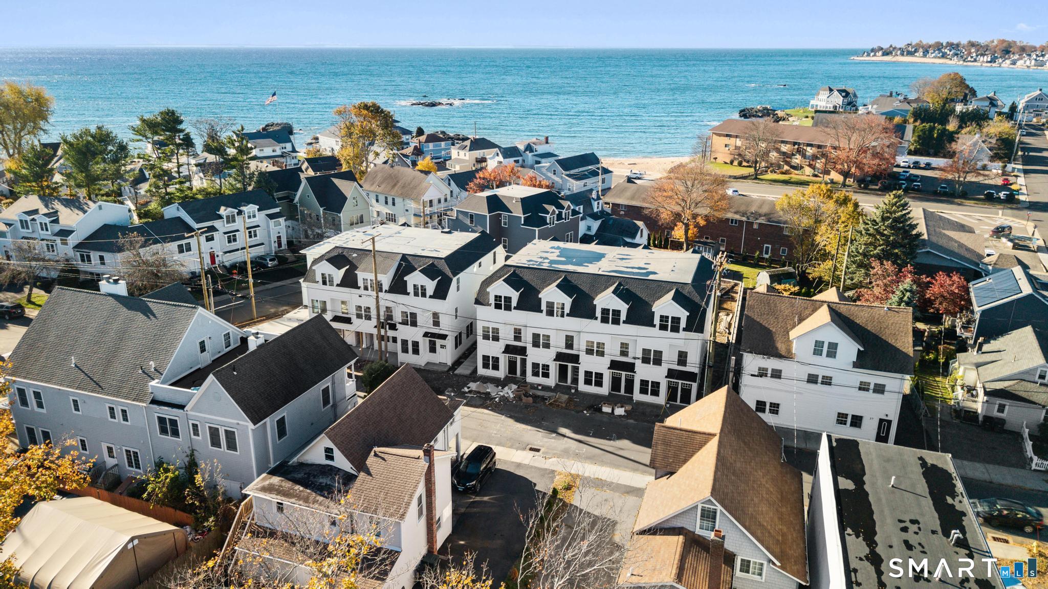27 Village Road, Unit B Milford, CT 06460 - Photo 3 of 14 an aerial view of a building with outdoor space and ocean view