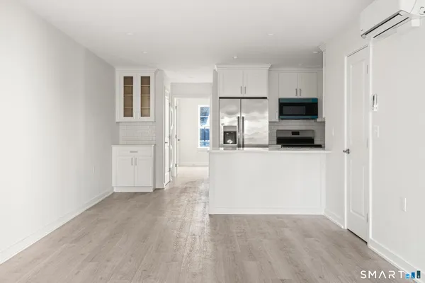a kitchen with stainless steel appliances a refrigerator and a stove top oven