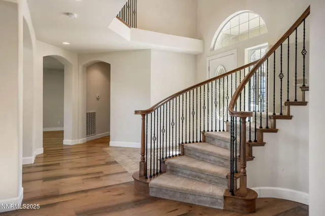 a view of entryway with wooden floor and stairs