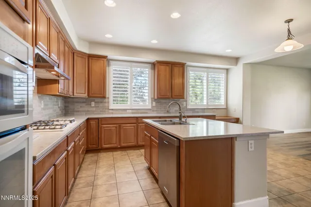 a kitchen with a sink stove top oven and cabinets