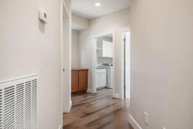 a view of a hallway with wooden floor