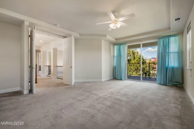 an empty room with fan and door