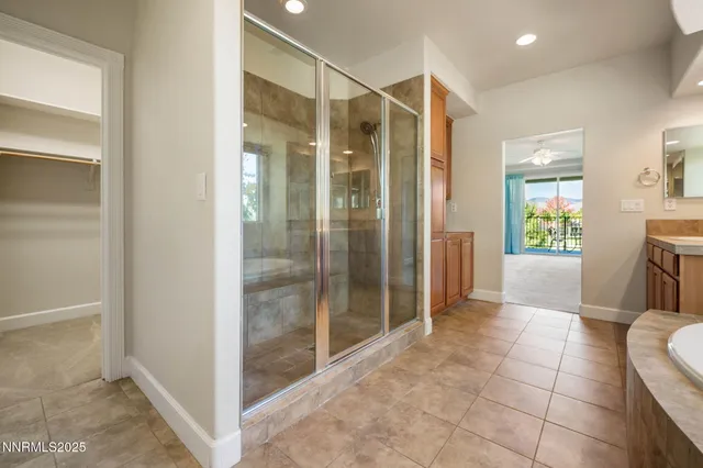 a bathroom with a glass shower door and a sink