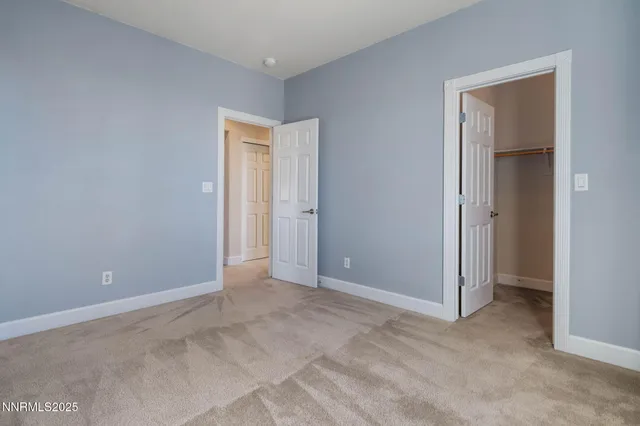 a view of an empty room and closet area