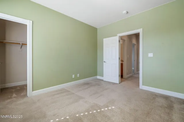 a view of an empty room with closet