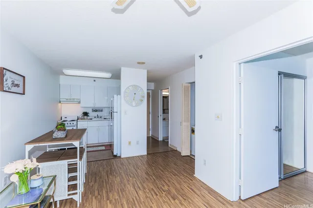a living room with furniture and a kitchen view