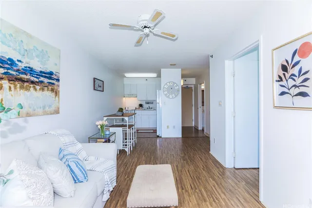 a view of a kitchen with fridge and wooden floor