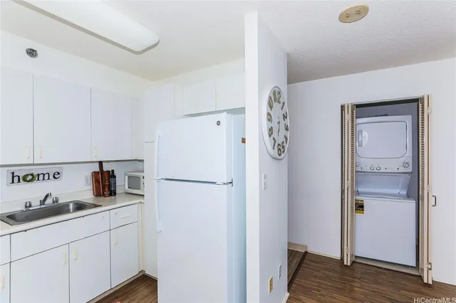 a kitchen with stainless steel appliances granite countertop a sink a stove and cabinets
