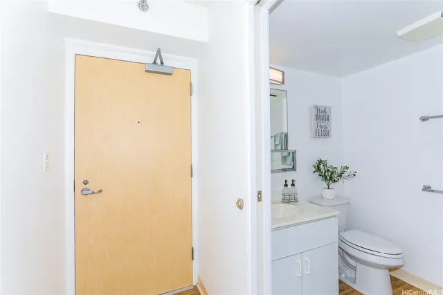 a white toilet sitting next to a bathroom sink