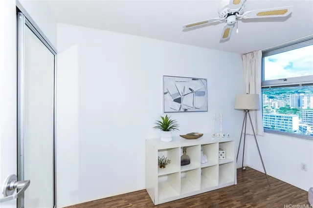a view of a hallway with wooden floor and a potted plant
