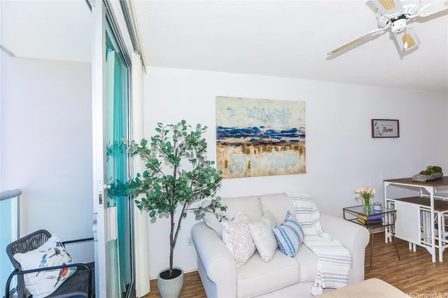 a living room with furniture and a chandelier