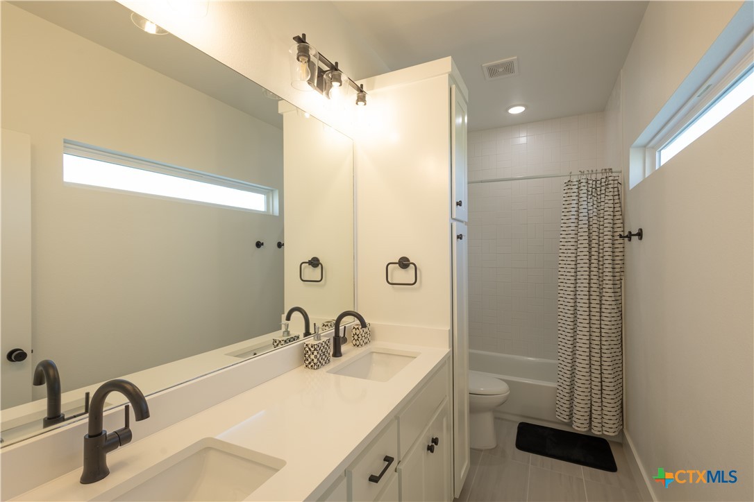 4324 Cedar Creek Road Temple, TX 76504 - Photo 37 of 45 a bathroom with a sink a toilet a mirror and shower