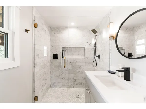 a bathroom with a sink vanity and a mirror