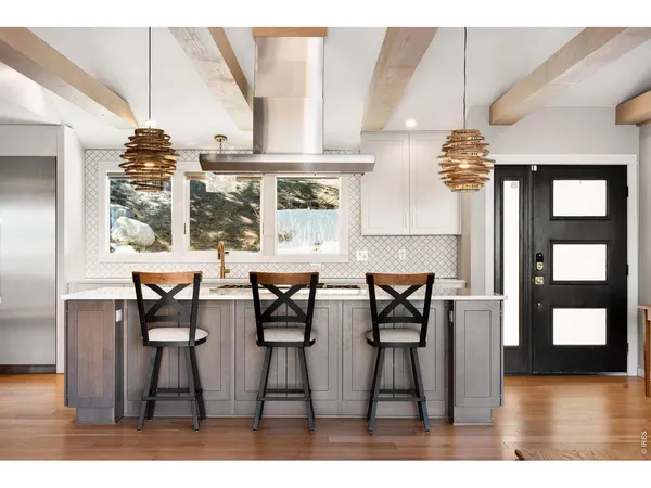 a kitchen with stainless steel appliances granite countertop a sink stove and cabinets