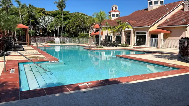 an aerial view of a house with swimming pool and patio