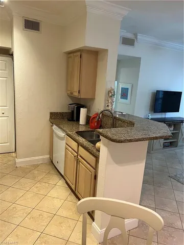 a kitchen with granite countertop a sink and a stove