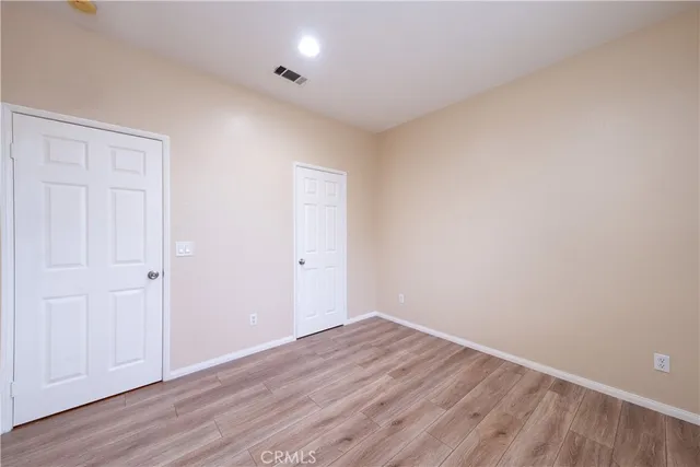 a view of room with wooden floor