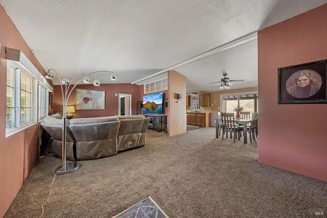 a view of a dining room with furniture and a window