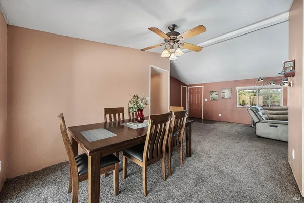 a large kitchen with stainless steel appliances wooden cabinets a stove and a sink