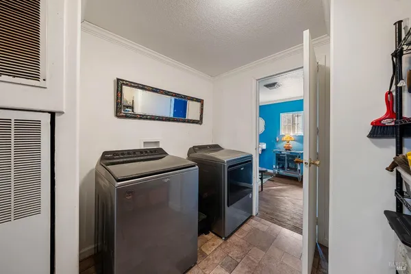 a view of a livingroom with furniture wooden floor windows and a chandelier