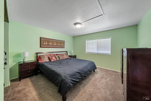 a bathroom with a granite countertop sink toilet a mirror and shower