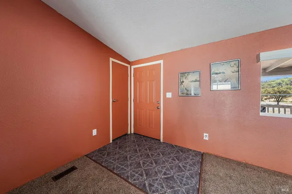 a living room with furniture a flat screen tv and a floor to ceiling window