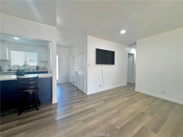 a view of kitchen with wooden floor and electronic appliances