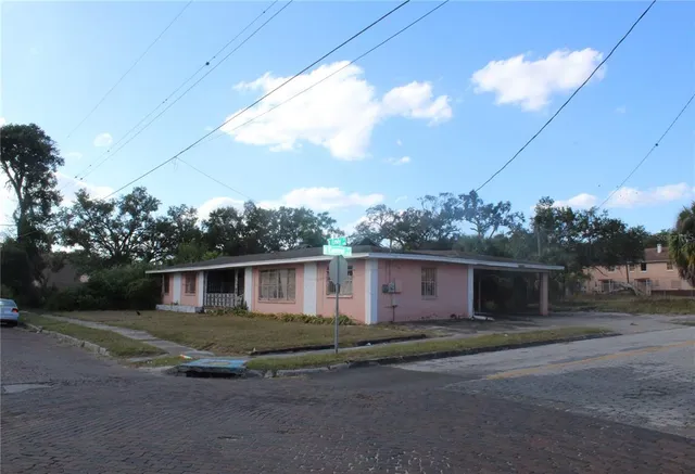 a view of a porch with furniture and a yard