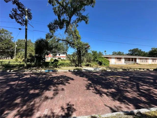 a view of a yard with a tree in the background