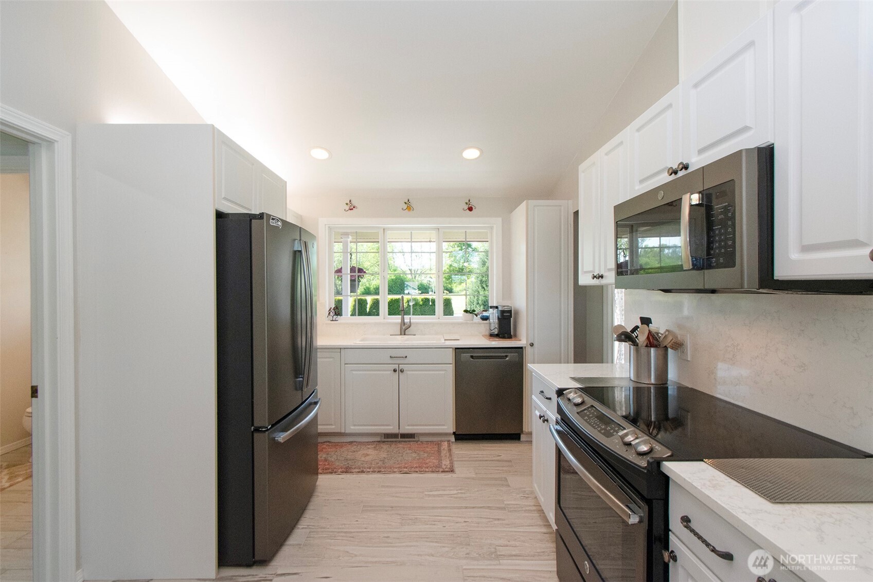 23 Pearl Place Sequim, WA 98382 - Photo 12 of 40 a kitchen with stainless steel appliances granite countertop a refrigerator sink and stove